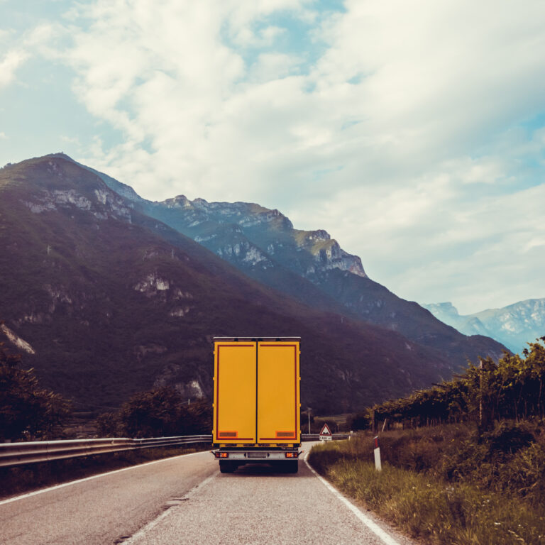 truck on the road.  Yellow cargo car